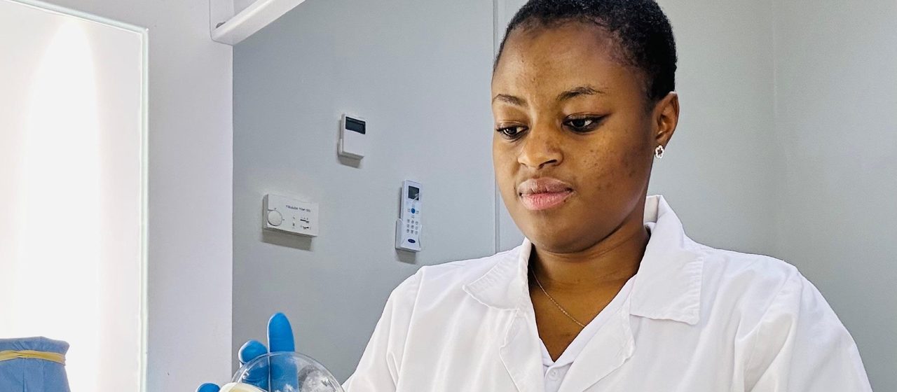 SMP scientists working in a laminar-flow laboratory — the analytical science behind operational excellence, world-class manufacturing and continuous improvement consulting