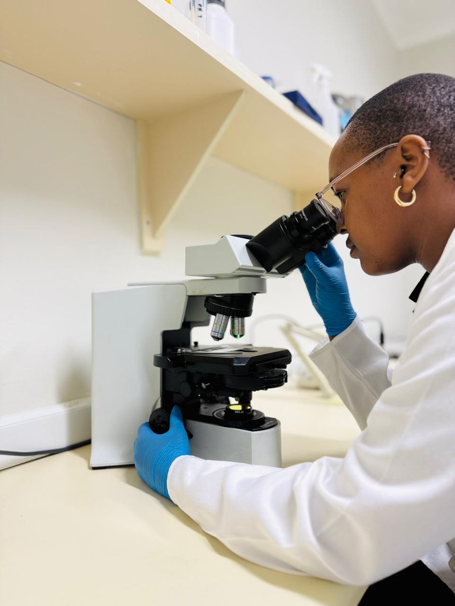 SMP scientist Lizette examining a sample under the microscope in the laboratory — the analytical rigour SMP brings to production quality