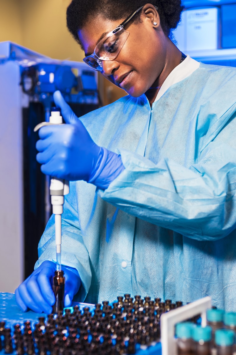 Laboratory analyst pipetting a sample for testing — SMP's analytical rigour applied to production quality