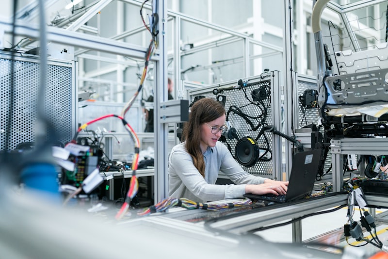 Engineer at work on a manufacturing production line — SMP's operational depth applied where production actually happens
